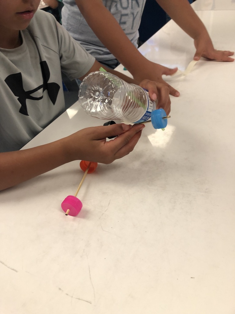 students working with a balloon powered car