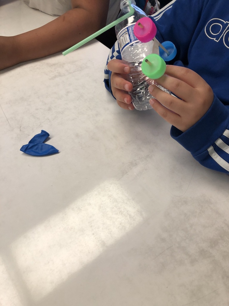 students working with a balloon powered car